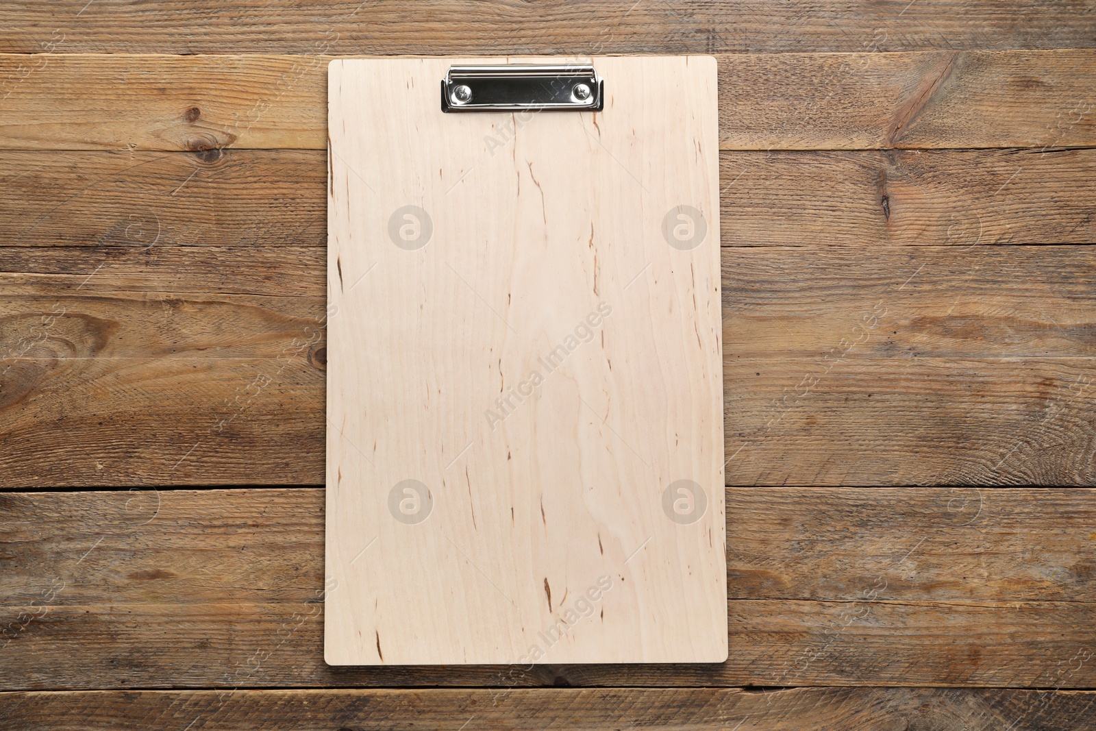 Photo of One clipboard on wooden table, top view