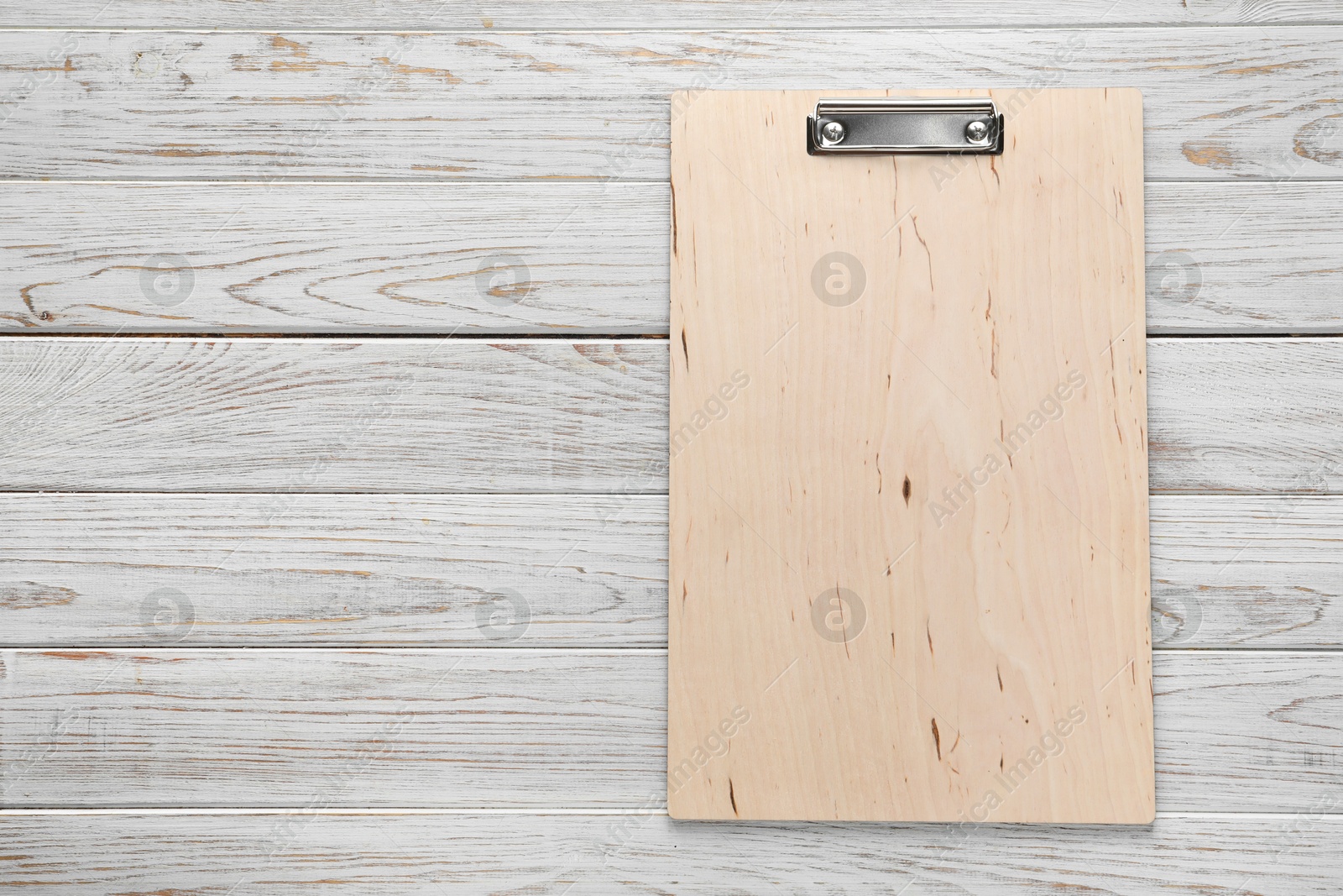 Photo of One clipboard on wooden table, top view. Space for text