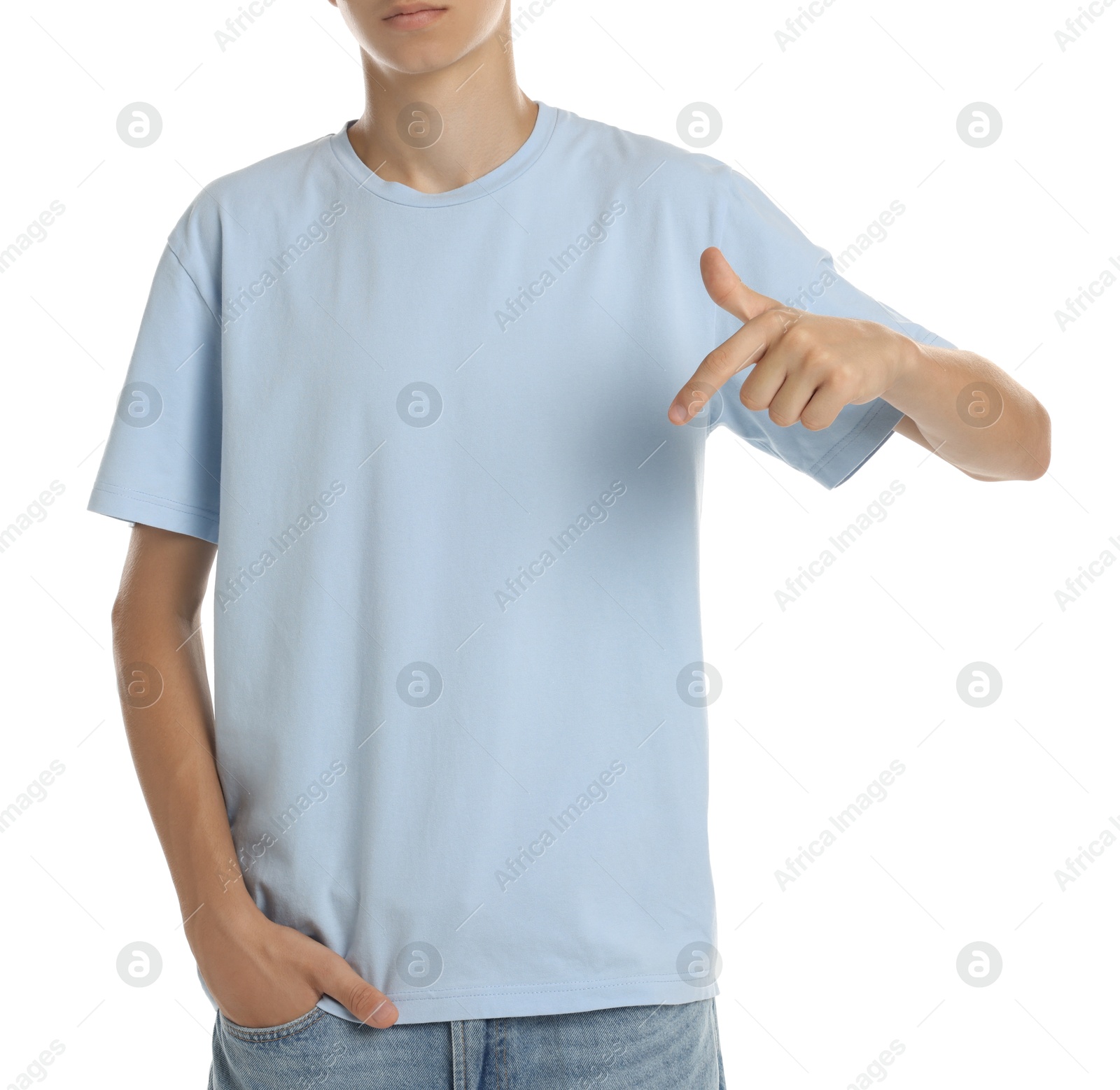 Photo of Teenage boy wearing light blue t-shirt on white background, closeup