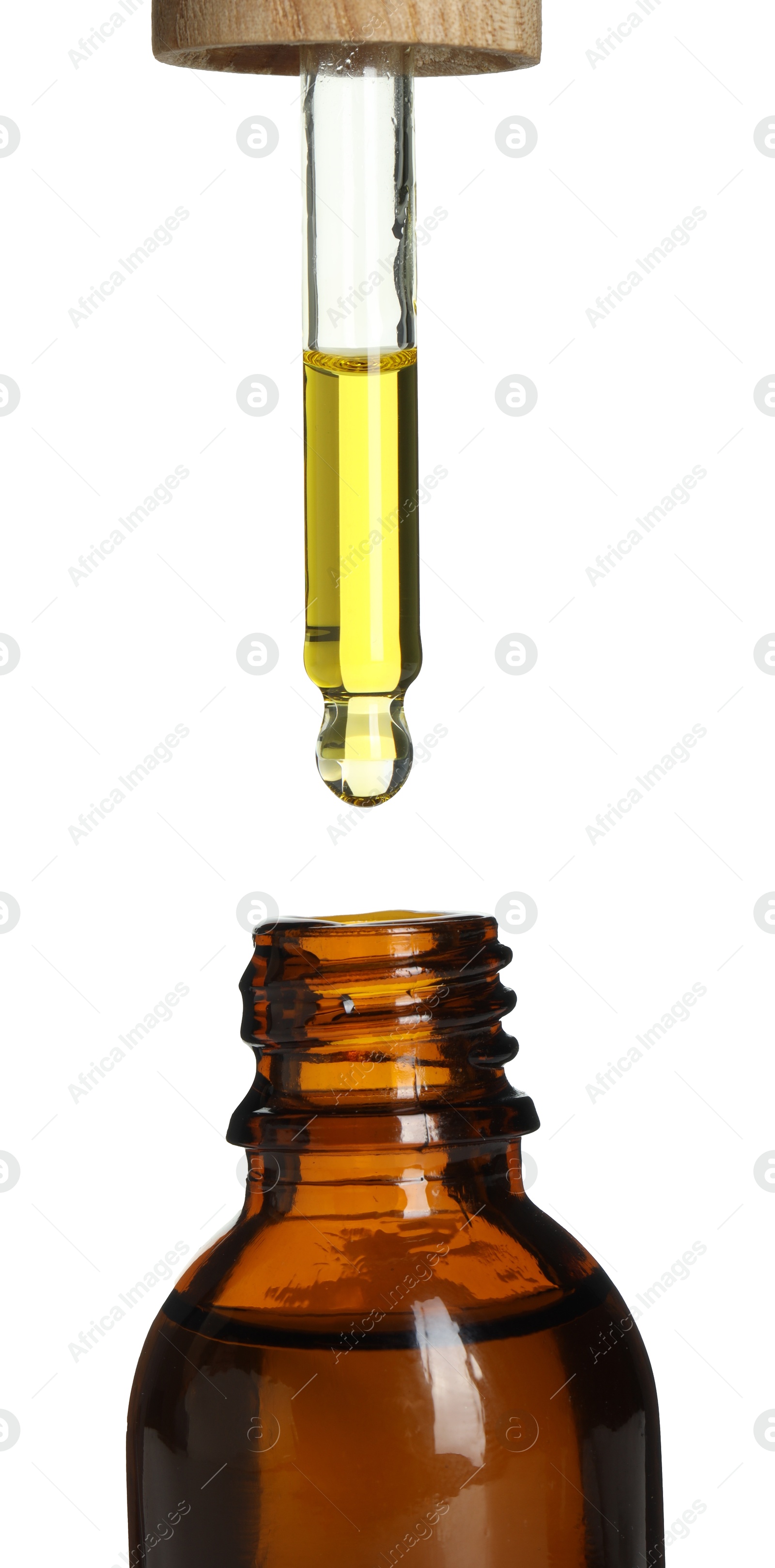 Photo of Dripping tincture from pipette into bottle on white background, closeup