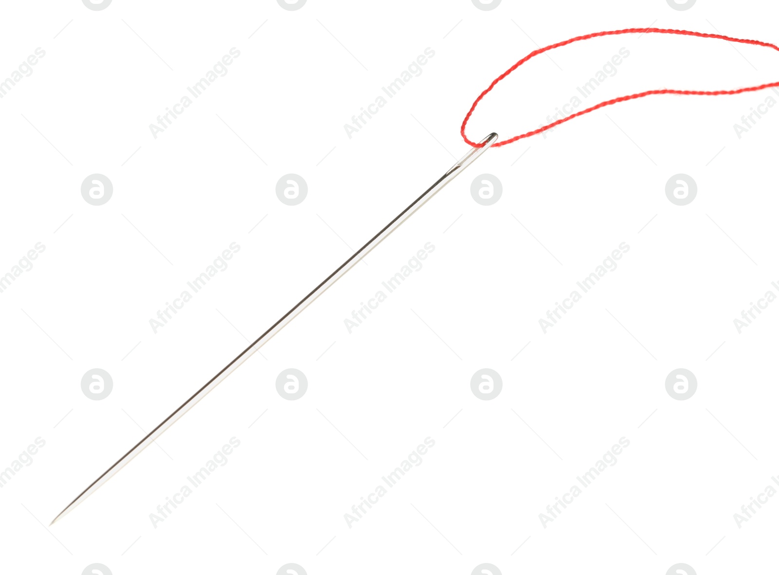 Photo of Sewing needle with red thread isolated on white