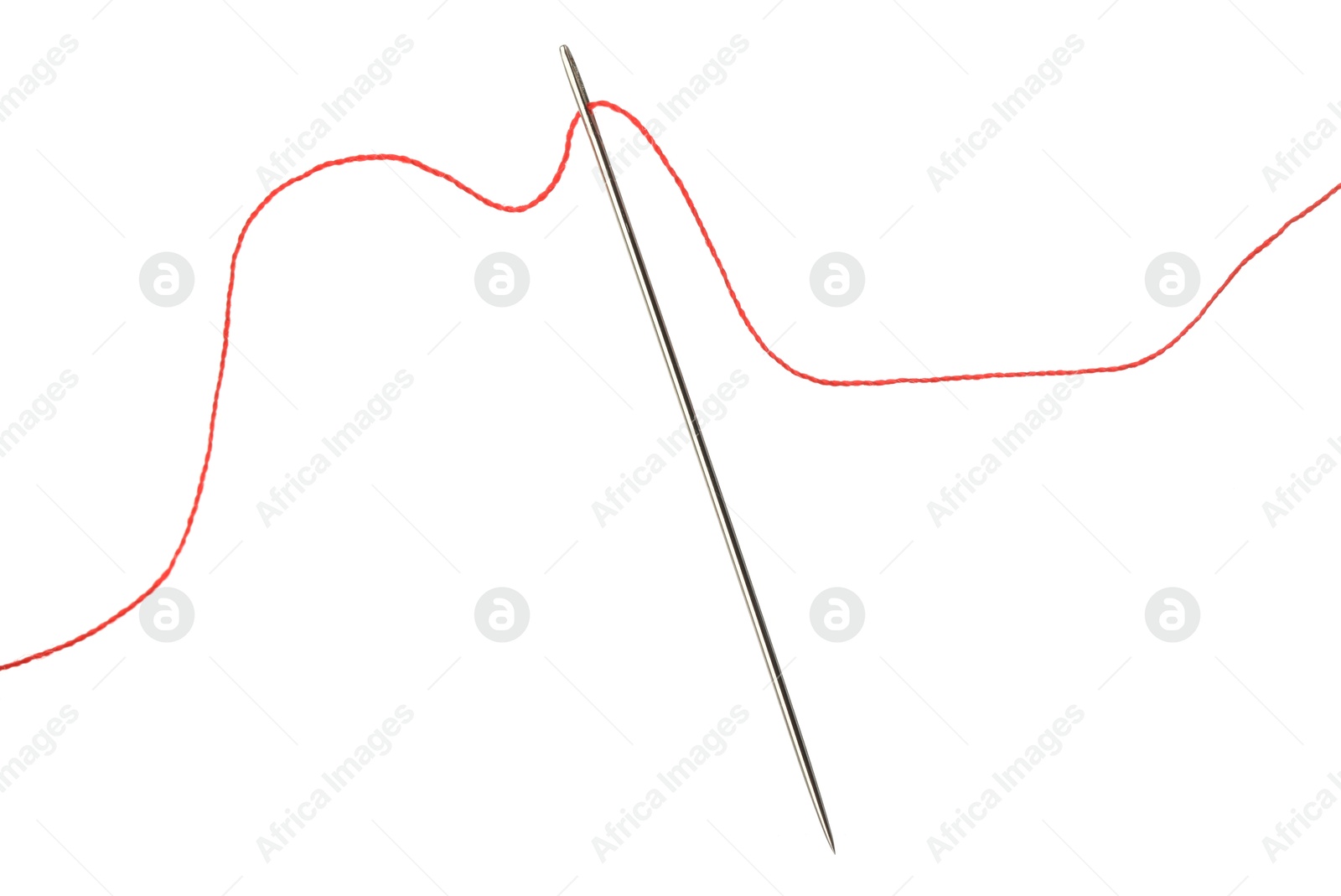 Photo of Sewing needle with red thread isolated on white