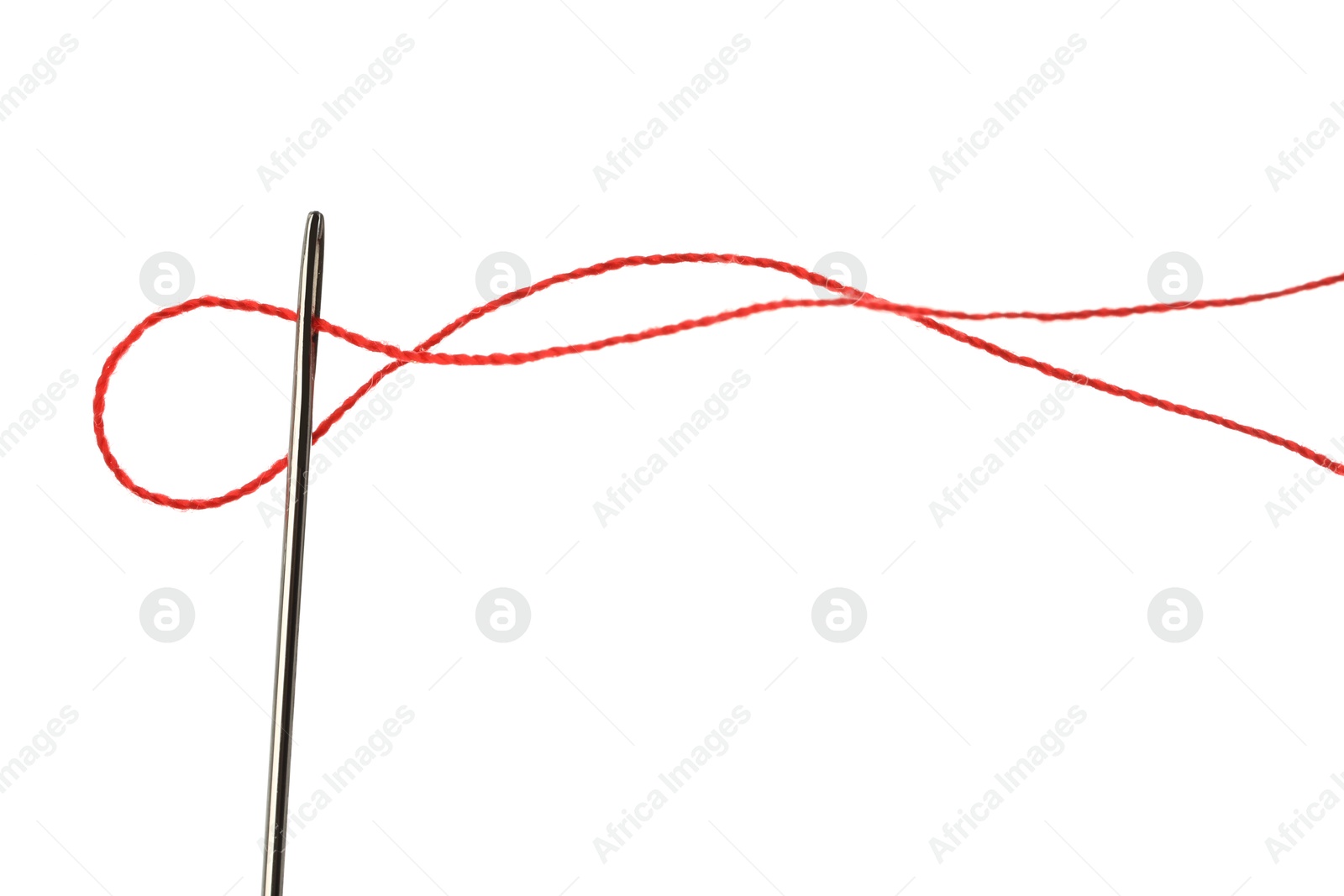 Photo of Sewing needle with red thread isolated on white