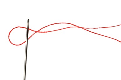 Photo of Sewing needle with red thread isolated on white