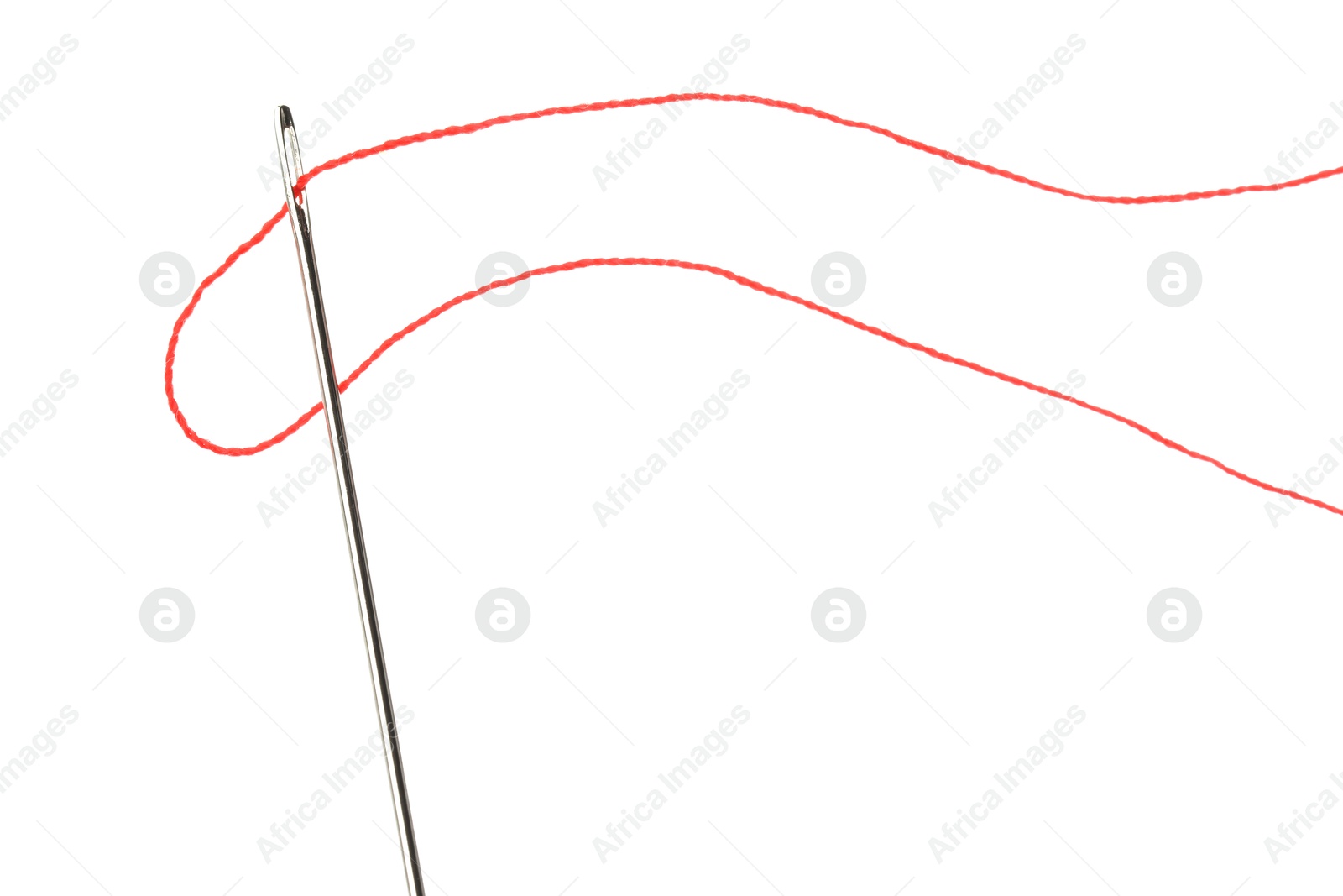 Photo of Sewing needle with red thread isolated on white