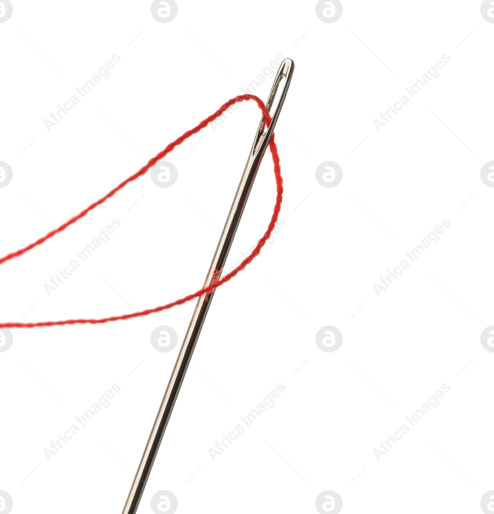 Photo of Sewing needle with red thread isolated on white