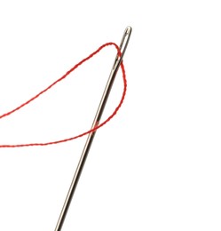 Photo of Sewing needle with red thread isolated on white