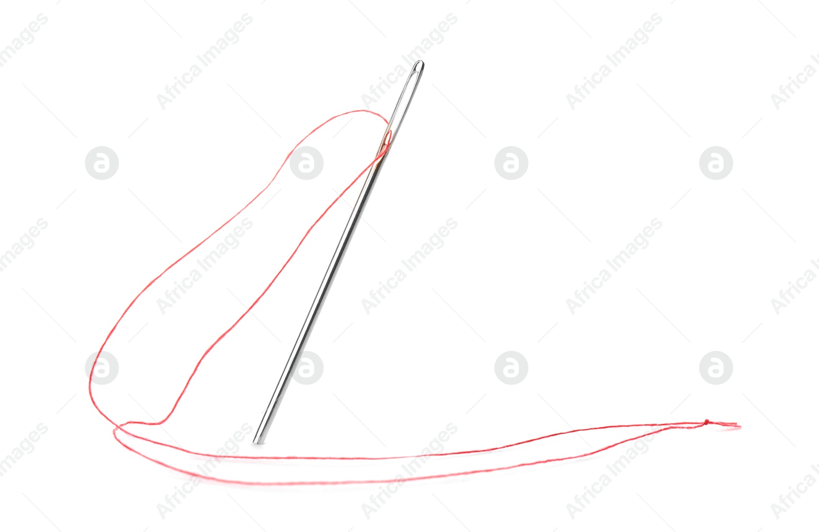 Photo of Sewing needle with red thread isolated on white