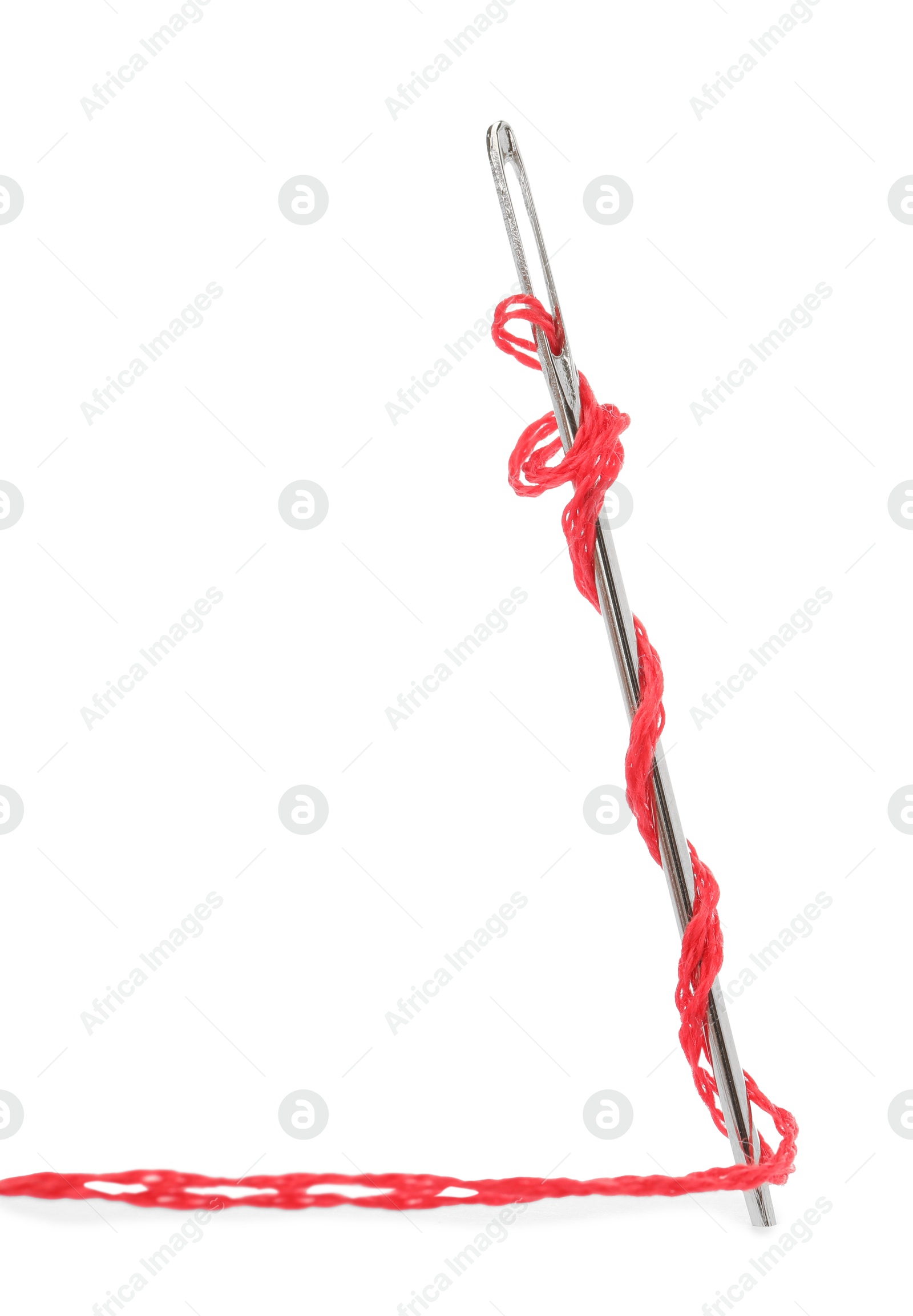 Photo of Sewing needle with red thread isolated on white