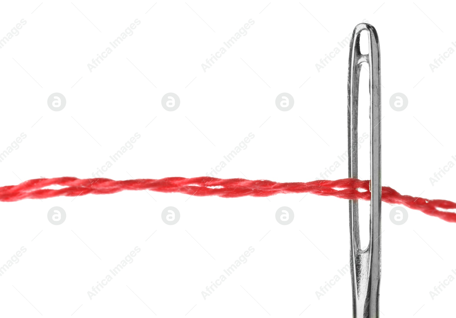 Photo of Sewing needle with red thread isolated on white, closeup