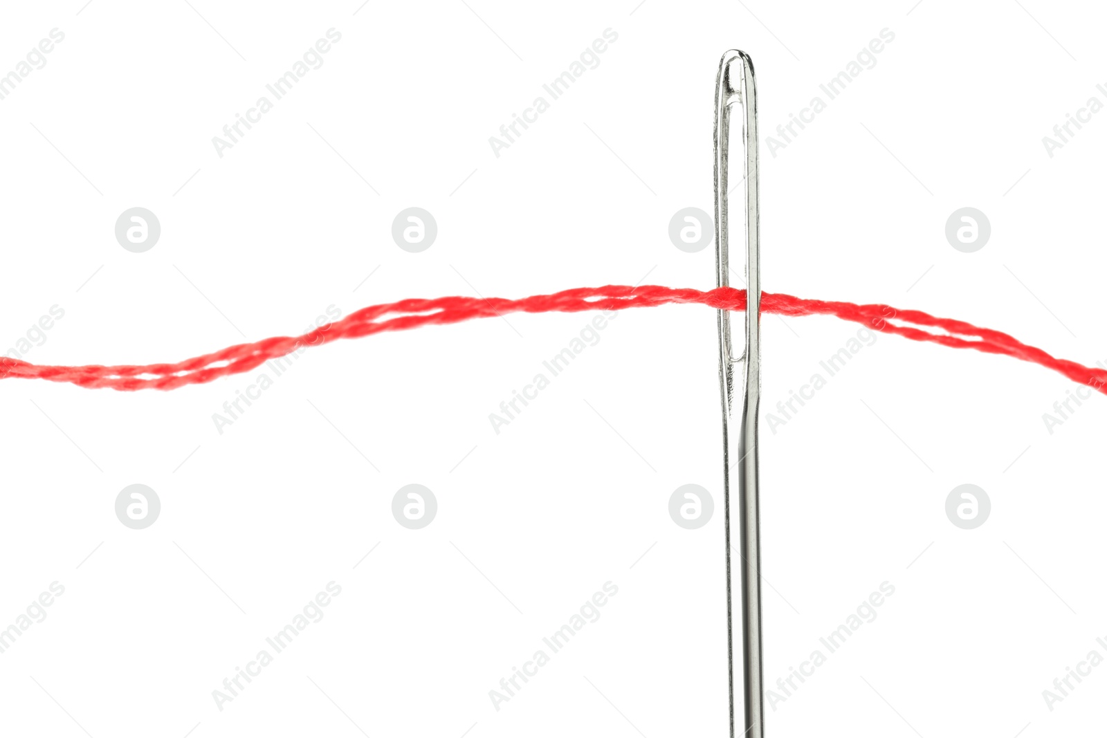 Photo of Sewing needle with red thread isolated on white, closeup