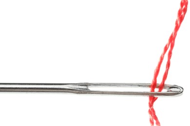 Photo of Sewing needle with red thread isolated on white, closeup