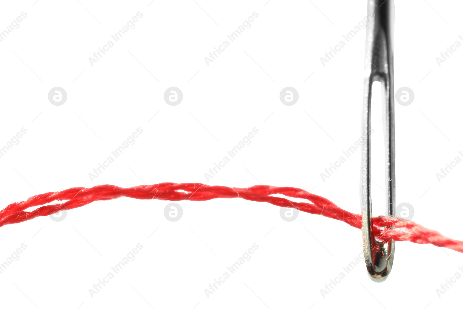 Photo of Sewing needle with red thread isolated on white, closeup