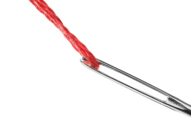 Photo of Sewing needle with red thread isolated on white, closeup