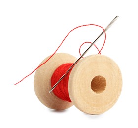 Photo of Spool of red sewing thread with needle isolated on white