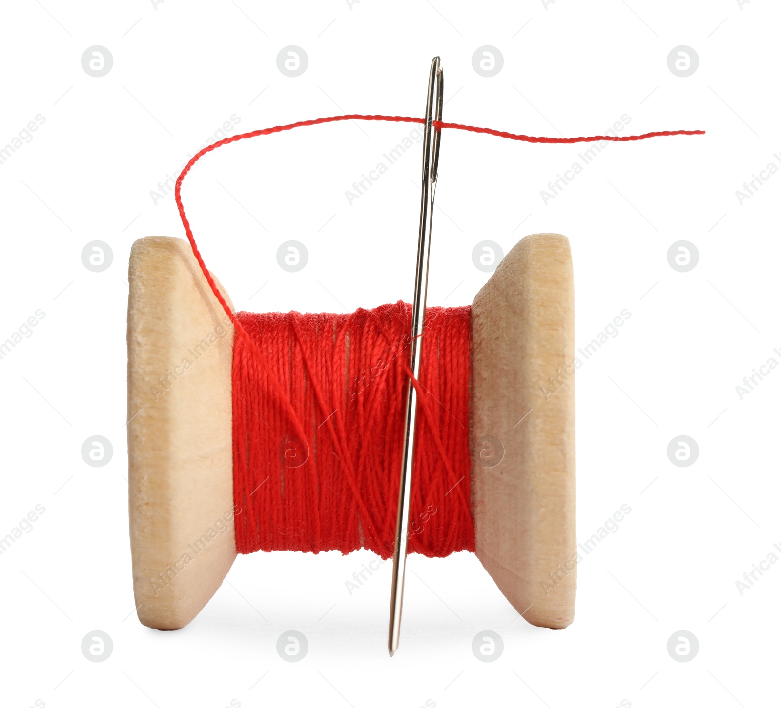 Photo of Spool of red sewing thread with needle isolated on white