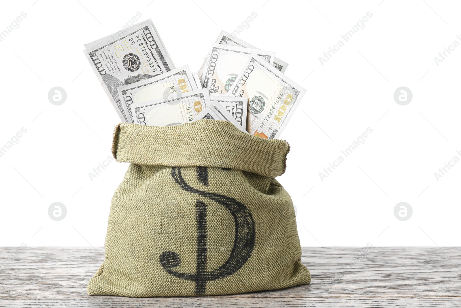 Photo of Dollar banknotes in bag on wooden table against white background