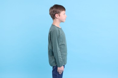 Photo of Boy with correct posture on light blue background