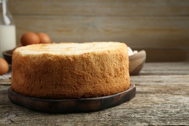 Photo of Tasty fresh sponge cake on wooden table