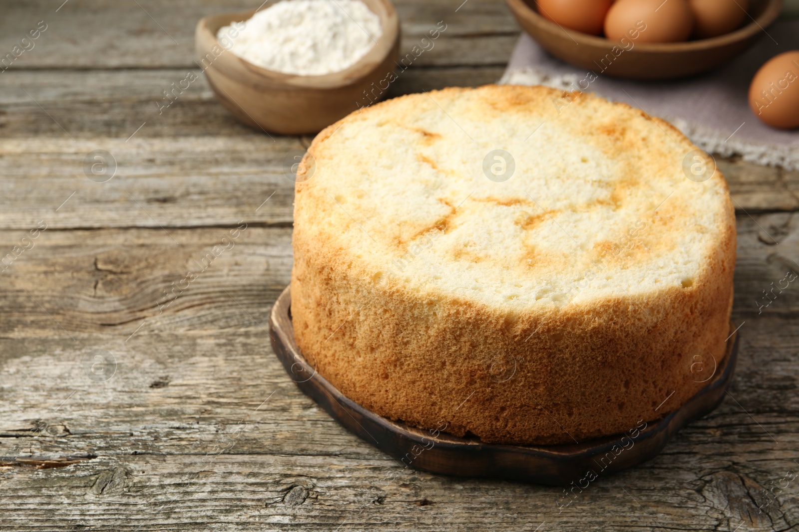 Photo of Tasty fresh sponge cake on wooden table