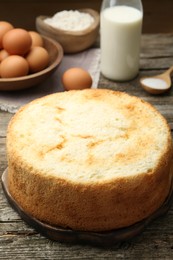 Photo of Tasty fresh sponge cake on wooden table