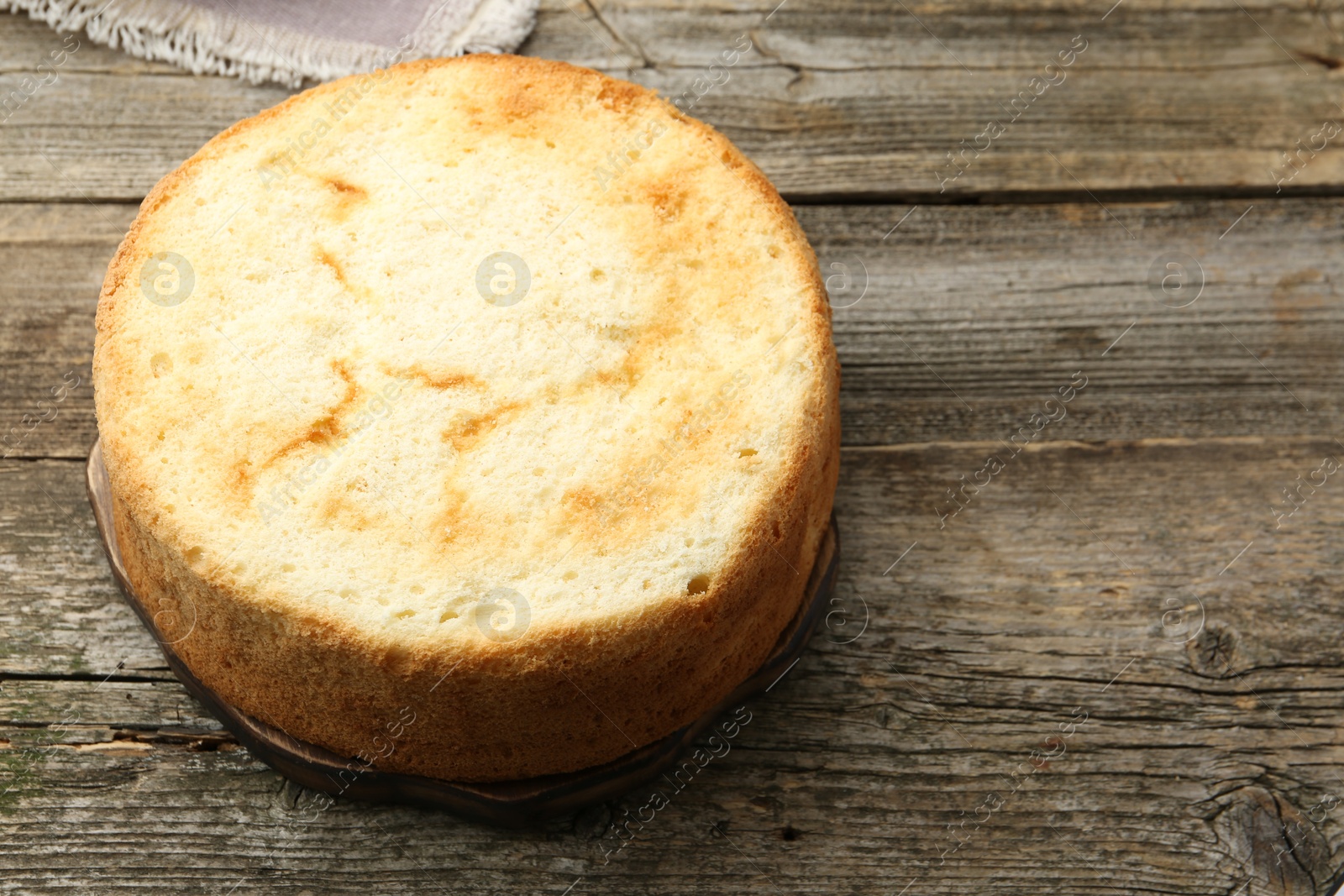 Photo of Tasty sponge cake on wooden table, space for text