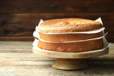 Photo of Tasty cut sponge cake on wooden table