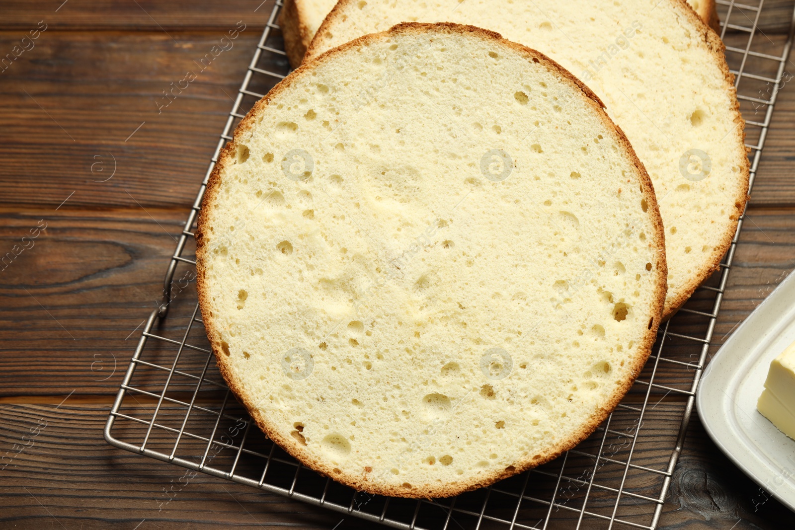 Photo of Tasty cut sponge cake on wooden table