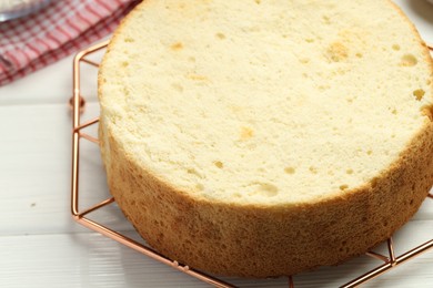 Photo of Tasty cut sponge cake on white wooden table, closeup