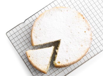 Photo of Delicious cut sponge cake with powdered sugar isolated on white, top view