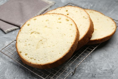 Photo of Delicious cut sponge cake on grey textured table