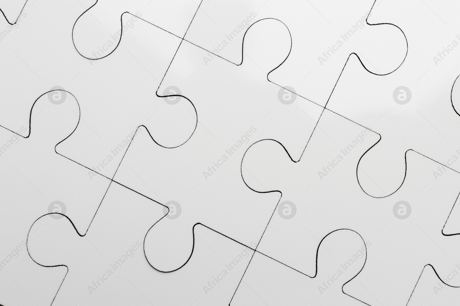 Photo of White puzzle as background, top view. Intellectual game