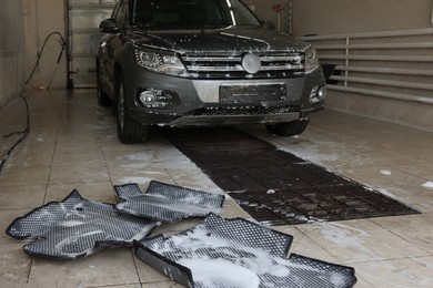 Car floor mats covered with foam and modern auto indoors