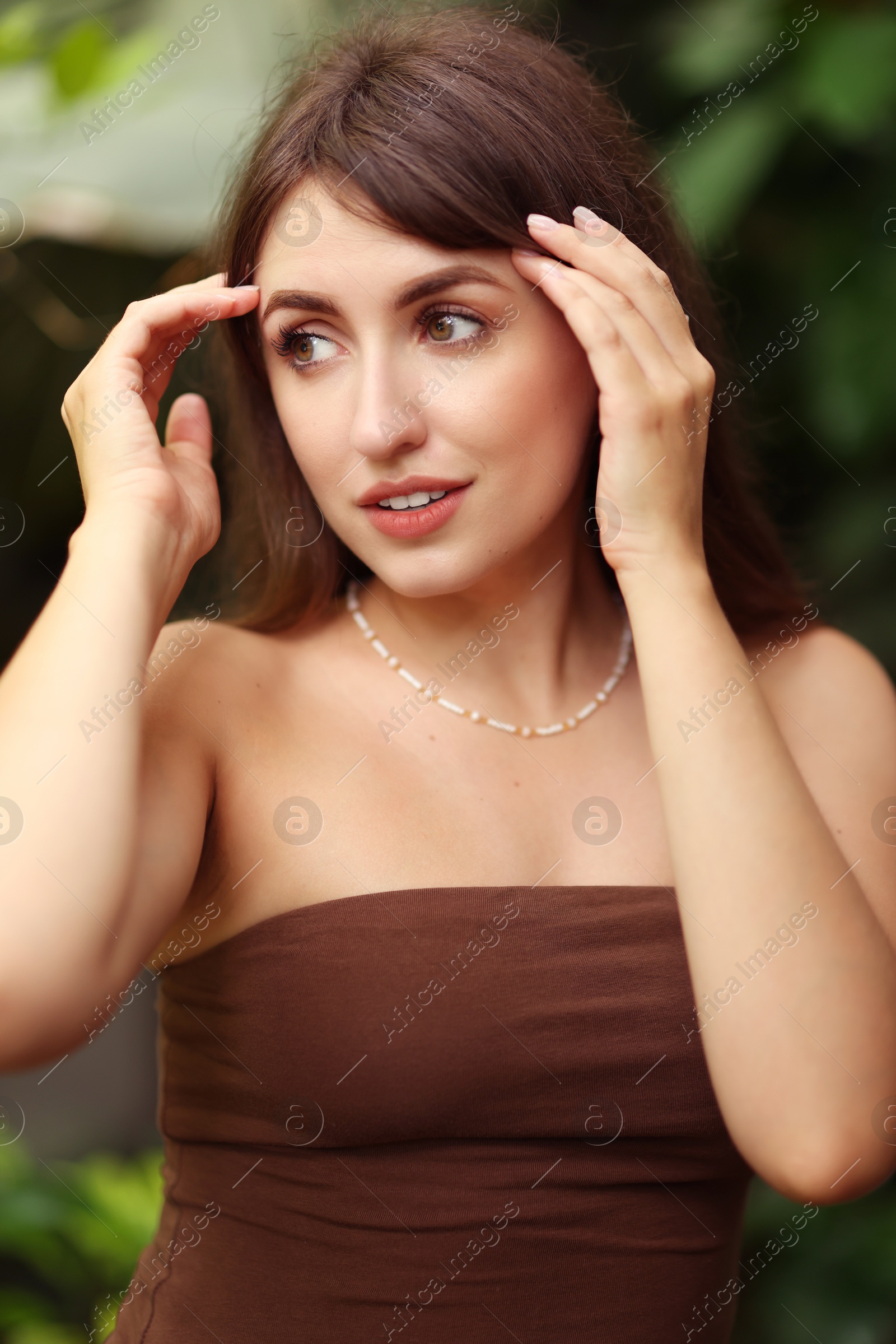 Photo of Portrait of beautiful woman in dress outdoors