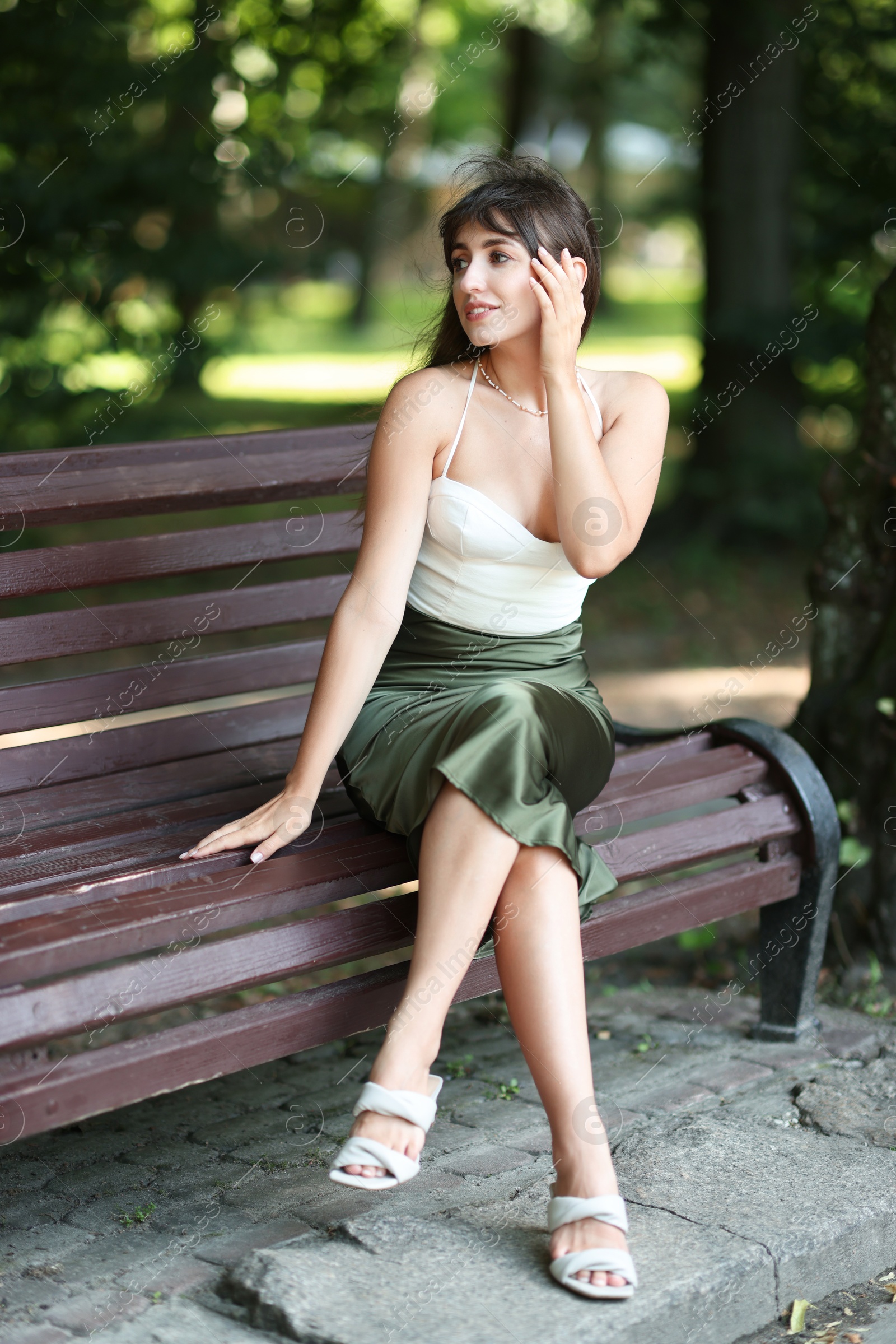 Photo of Beautiful woman sitting on bench in park