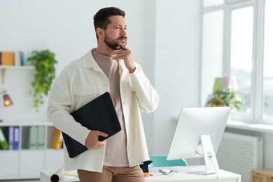 Photo of Professional designer with tablet working in office