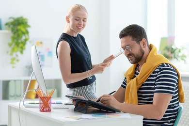 Photo of Designers with tablets working together in office