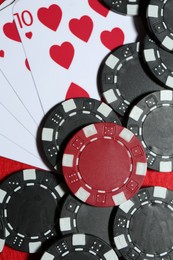 Playing cards and poker chips on table, flat lay