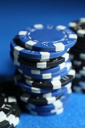 Poker game. Casino chips on blue table, closeup