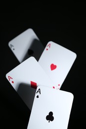 Photo of Poker game. Playing cards on black background, closeup