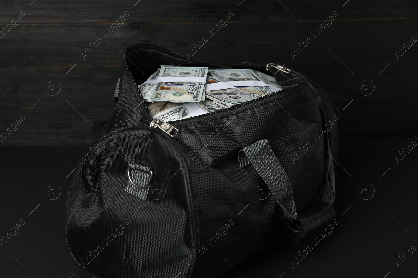 Photo of Dollar banknotes in bag on black table