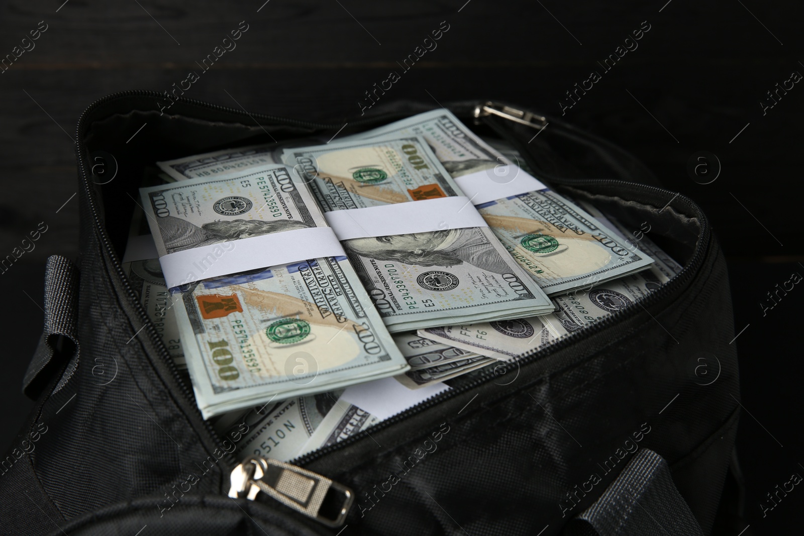 Photo of Dollar banknotes in bag on table, closeup