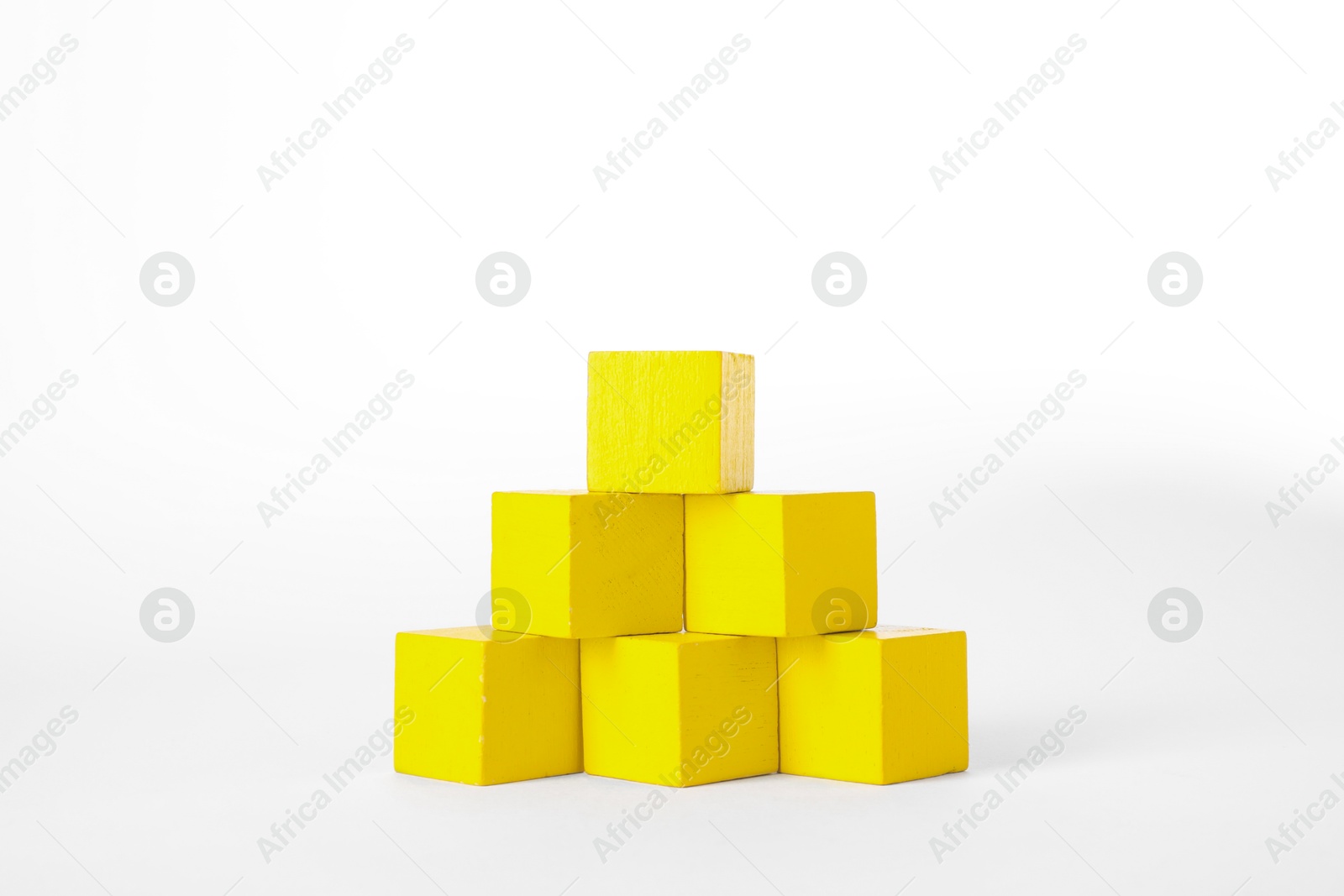 Photo of Many yellow wooden cubes isolated on white