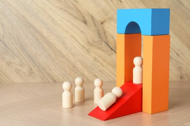 Photo of Color stand with human figures on wooden table