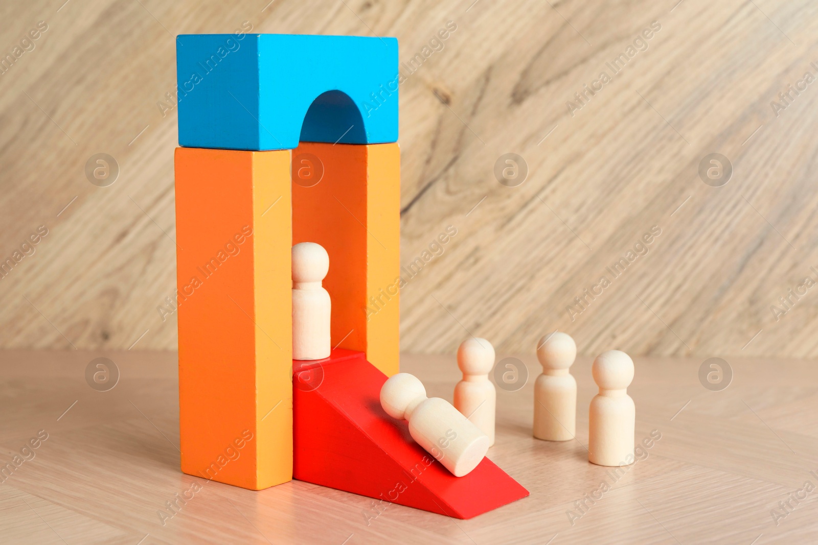 Photo of Color stand with human figures on wooden table