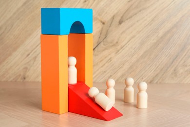 Photo of Color stand with human figures on wooden table