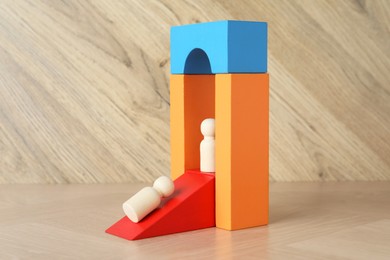 Photo of Color stand with human figures on wooden table