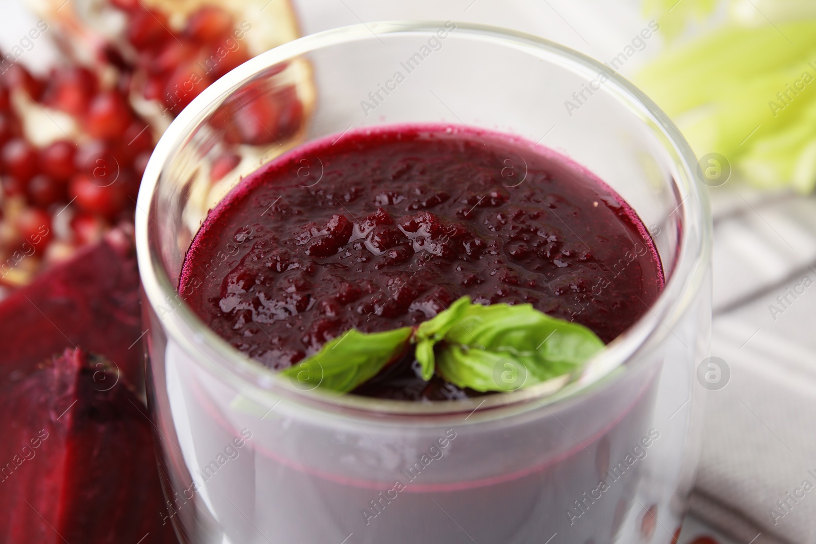 Photo of Fresh beetroot smoothie with mint in glass on table, closeup