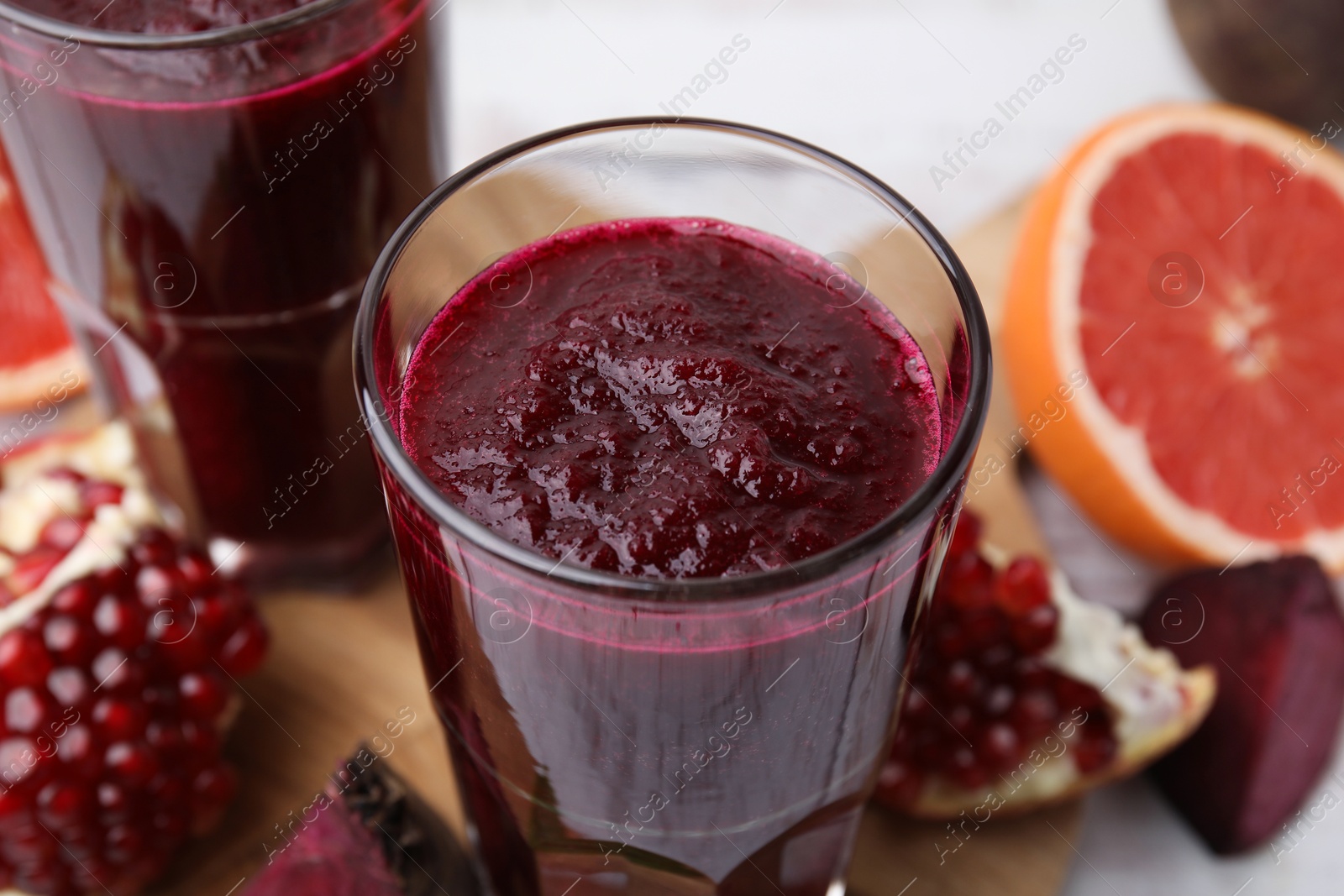 Photo of Fresh beetroot smoothie in glasses on table, closeup