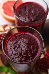 Fresh beetroot smoothie in glasses on table, closeup